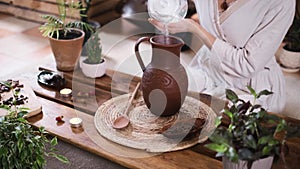 Pouring water into jug with cacao. Ceremonial cocoa ritual