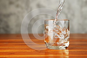 Pouring water splash into a glass.