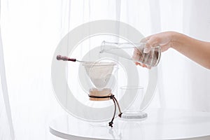 Pouring Water to the Coffee Pot on White Wall and White Table, Manual Brew, Hand Drip Coffee