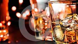 Pouring whiskey on bar table near bottles warm atmosphere