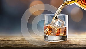 Pouring whiskey from bottle into glass on bar counter