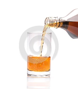 Pouring whisky into glass on white background