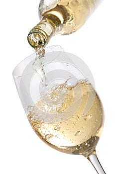 Pouring white wine into a glass photo