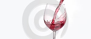 Pouring wine into a glass on a light background