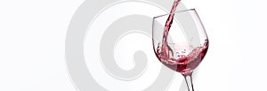 Pouring wine into a glass on a light background