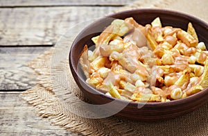 Poutine Canadian homemade traditional fast food meal with fries, curd