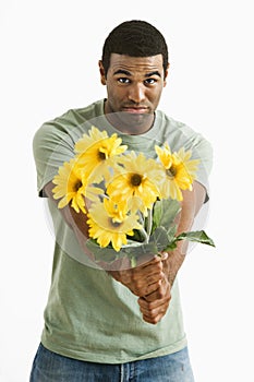 Pouting man with bouquet.