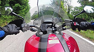 POV Biker Rides on a Motorbike by Forested Mountain Road in Italy