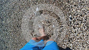 POV Boy walking to sea with glasses in hands to swim