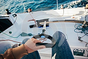 POV of captain steering wheel of sailboat