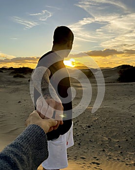 Pov of couple holding hands and enjoying together a great sunset time. Travel and holiday summer vacation people in love or