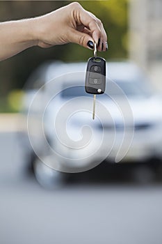 Pov defocused on background and woman hand with key