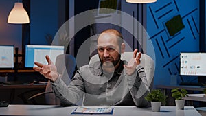 Pov of exhausted businessman sitting at desk table having company webinar