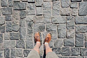 POV feet selfie legs walking street pavement top view. Abstract travel selfie shoes walking pavement stone pathway. Old
