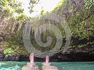 POV of female feet with nail polish floating in To Sua Trench sw