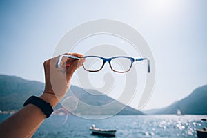 POV woman hold prescription glasses