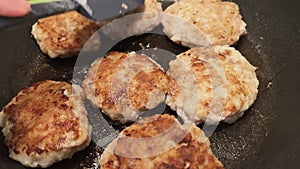 POV flip over fried cutlets on frying pan. Moving patty cakes. Cooking at home. Tasty homemade food. Turn over meat