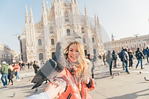 POV image of two girls best friends holding hands and making picture in the square of Milan Duomo