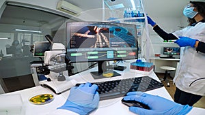 POV of man biologist checking DNA informations typing on pc