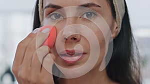 Pov model applying foundation indoors. Portrait lady using makeup visage sponge