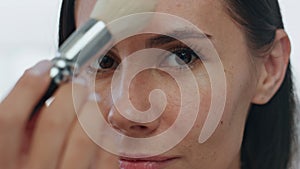 Pov morning girl makeup routine indoors. Portrait woman applying powder alone