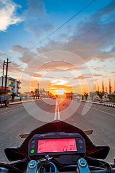 POV Motorbike Speedometer Against The Setting Sun on the Highway