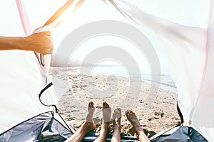 Pov photo of feets inside camping tent on the beach