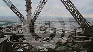 POV the rise inside the Elevator to the Eiffel tower - iron girders pass camera as elevator rises in Paris, France