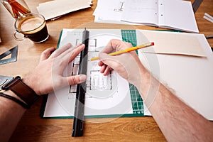 POV Shot Of Male Architect Working In Office Measuring Plans For New Building