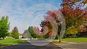 POV shot of suburban street in USA neighborhood on a beautiful Autumn day