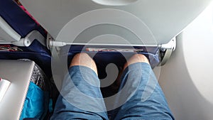 POV: Sitting in an uncomfortable economy class window seat with no leg room.