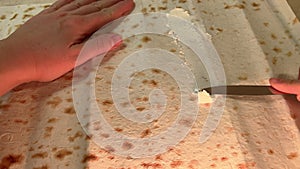 POV spreading cream cheese on pita bread. Cooking breakfast wrap at home. film grain pixel texture. soft focus. blur.