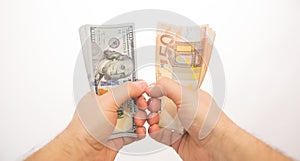 Pov two hands holding dollars and euros isolated