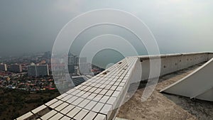 POV view from a man walking along the edge of the roof of a skyscraper