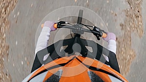 Pov view. One caucasian children ride bike road in autumn park. Little girl riding black orange mtb cycle in forest. Kid