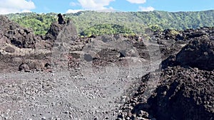 POV view walking around petrified volcanic lava rocks in summer. First person view of hiking trip through Black Lava
