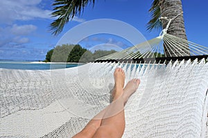 POV of a woman lay on a hammock relaxing in Muri lagoon in Rarotonga Cook Islands