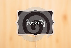 Poverty - card with text on blackboard about social issues and problems