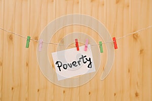 Poverty - card with text on clothespins about social issues and problems