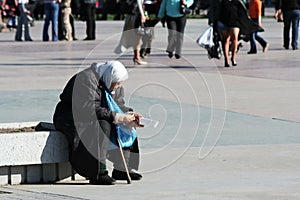 Poverty poor old woman on city street