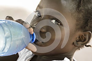 Poverty Symbol: African Black Girl Drinking Heathy Fresh Water.