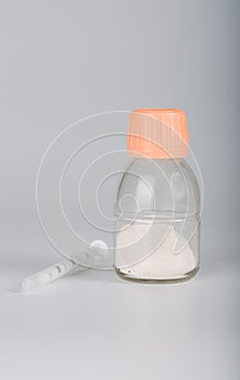 Powder antibiotics in a glass bottle with syringe.