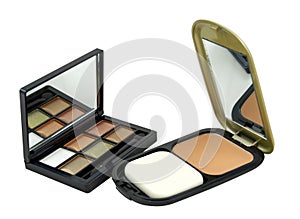 Powder and eye shadow kit on a white