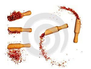 powder paprika with wooden spoon flying scoop isolated on white background