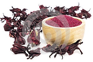 Powder of Roselle flower buds in wooden bowl on white background