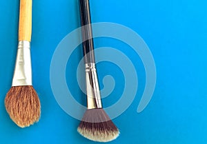 Powder slide, a touch of foundation and two black makeup brushes