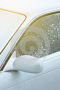 Powdered car with the first snow, the problem of cleaning the windshield with wipers in the cold. Front and back background