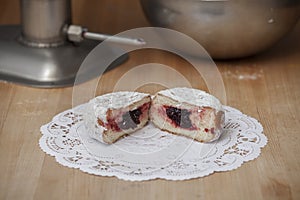 Powdered Jelly Donut on Bakers Table