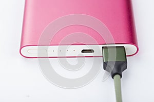 Power bank for charging mobile devices. Pink smart phone charger with power bank. battery bank