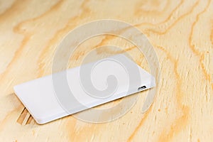 Power bank small mini size on wooden background